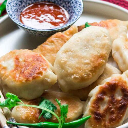 Pan fried Chicken Momo served with Momo dipping sauce