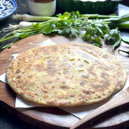 Aloo Paneer Paratha served on wooden platter